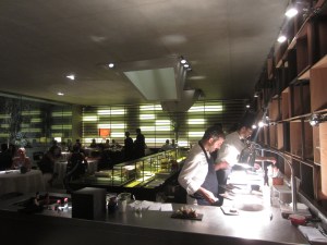 The open kitchen, chef's counter, and the dining room. Chef Felip Llufriu is closest.